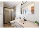 Well-lit bathroom featuring a walk-in shower, a vanity, and modern fixtures at 16225 W 74Th Dr, Arvada, CO 80007