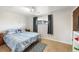 Bedroom featuring tiled floors, a comfortable bed, and a window with natural light at 16225 W 74Th Dr, Arvada, CO 80007