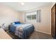 Bedroom with neutral carpet, light walls, and a bright window at 16225 W 74Th Dr, Arvada, CO 80007