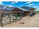 Horse property featuring a chicken coop with a green metal gate and a dirt lot at 16225 W 74Th Dr, Arvada, CO 80007