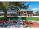 Charming house features brick and siding, mature tree, landscaping, and a cozy front yard at 16225 W 74Th Dr, Arvada, CO 80007