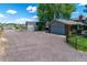 A long gravel driveway to the right of the house leads to a two-car garage and storage shed at 16225 W 74Th Dr, Arvada, CO 80007