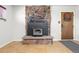 Stone fireplace with a wood-burning stove and a dartboard on the wall at 16225 W 74Th Dr, Arvada, CO 80007