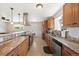 Well-lit kitchen featuring granite counters, stainless steel appliances, and custom wood cabinetry for ample storage and style at 16225 W 74Th Dr, Arvada, CO 80007