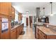 Spacious kitchen with granite countertops, stainless steel appliances, and a breakfast bar that connects to the living area at 16225 W 74Th Dr, Arvada, CO 80007