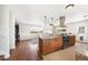 Open kitchen with stainless steel appliances, granite countertops, and warm wood cabinets, connecting to the living area at 16225 W 74Th Dr, Arvada, CO 80007