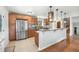 Modern kitchen with stainless steel appliances, custom cabinetry, a center island and open layout to the other rooms at 16225 W 74Th Dr, Arvada, CO 80007