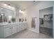 Double vanity bathroom with a large mirror and plenty of storage at 21937 E 51St Dr, Aurora, CO 80019