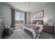 Cozy bedroom with a comfortable bed and large window at 21937 E 51St Dr, Aurora, CO 80019