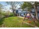 Landscaped backyard featuring a swing set, covered bench swing, and patio at 247 Regal St, Louisville, CO 80027