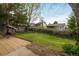 A green, well-maintained backyard with a patio, lush trees, and ample space at 247 Regal St, Louisville, CO 80027