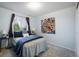 Comfortable bedroom with a colorful abstract painting and a window with a view at 247 Regal St, Louisville, CO 80027