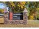 Stone sign for Cottonwood Park, surrounded by trees at 247 Regal St, Louisville, CO 80027