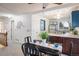 Dining area with an open view to the kitchen and stairs to the upper level with decoratively adorned walls at 247 Regal St, Louisville, CO 80027