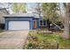 Charming blue single-Gathering home featuring a well-maintained lawn, garden bed, and a two-car garage at 247 Regal St, Louisville, CO 80027