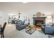 Bright living room with a cozy fireplace, skylight, and open layout, seamlessly connected to the kitchen and dining area at 247 Regal St, Louisville, CO 80027