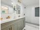 The modern bathroom has double sinks and a glass-enclosed shower at 11842 W 14Th Ave, Lakewood, CO 80401