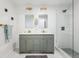 The modern bathroom has double sinks and a glass-enclosed shower at 11842 W 14Th Ave, Lakewood, CO 80401