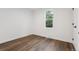 This bedroom features hardwood floors and a window letting in natural light at 11842 W 14Th Ave, Lakewood, CO 80401