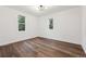 This bedroom features hardwood floors and two windows that offer natural light at 11842 W 14Th Ave, Lakewood, CO 80401