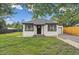 Charming single-story home featuring a well-maintained lawn, black trim, and inviting curb appeal at 11842 W 14Th Ave, Lakewood, CO 80401