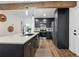 Modern kitchen with stainless appliances, an island, and beautiful wooden beam detail at 11842 W 14Th Ave, Lakewood, CO 80401