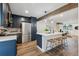 The updated kitchen features stainless steel appliances and a central island at 11842 W 14Th Ave, Lakewood, CO 80401