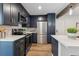 This kitchen features stainless steel appliances and dark cabinets at 11842 W 14Th Ave, Lakewood, CO 80401