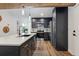 Modern kitchen with stainless appliances, an island, and beautiful wooden beam detail at 11842 W 14Th Ave, Lakewood, CO 80401