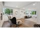Bright living room featuring recessed lights, modern decor, and large windows overlooking the yard at 11842 W 14Th Ave, Lakewood, CO 80401
