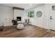Bright living room featuring a brick fireplace, dark wood floors and contemporary decor at 11842 W 14Th Ave, Lakewood, CO 80401
