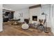 Bright living room featuring a brick fireplace, and dark wood floors with a dining nook at 11842 W 14Th Ave, Lakewood, CO 80401