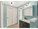 Bathroom with modern vanity, a marble countertop, and a large sliding-door closet for ample storage at 6836 E Briarwood Dr, Centennial, CO 80112
