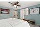 Calm bedroom with a ceiling fan, a plush white bed, and art with a view into hall at 6836 E Briarwood Dr, Centennial, CO 80112