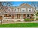 Charming brick townhouse with a cozy front porch and well-maintained landscaping, perfect for relaxing outdoors at 6836 E Briarwood Dr, Centennial, CO 80112