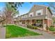 Brick and siding townhomes with cozy front porches and lush green landscaping at 6836 E Briarwood Dr, Centennial, CO 80112