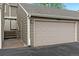 Attached garage with a beige door and the building number above the door at 6836 E Briarwood Dr, Centennial, CO 80112