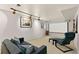 Cozy basement living room with a projector screen and modern decor, ideal for movie nights at 6836 E Briarwood Dr, Centennial, CO 80112