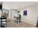 Home office with standing desk, ergonomic chair, wall shelving, and a large window at 6836 E Briarwood Dr, Centennial, CO 80112