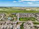 Expansive aerial view showing a well-maintained community with green spaces and mountain views at 10934 Touchstone Loop, Parker, CO 80134