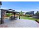 Backyard features a patio, gazebo with seating, privacy fence, and trampoline on lush grass at 10934 Touchstone Loop, Parker, CO 80134