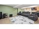 Entertainment basement with home theater seating, wet bar, and laminate flooring at 10934 Touchstone Loop, Parker, CO 80134
