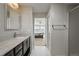 Bathroom featuring dual sinks and a shower, flowing to the main bedroom at 10934 Touchstone Loop, Parker, CO 80134