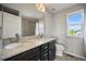 Bright bathroom with dual sinks, granite counters and shower with a tiled wall at 10934 Touchstone Loop, Parker, CO 80134