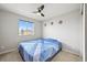 Comfortable bedroom featuring a ceiling fan, carpeted floor, and bright window view at 10934 Touchstone Loop, Parker, CO 80134