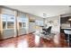 Dining area with hardwood floors, large windows offering ample natural light, and modern decor at 10934 Touchstone Loop, Parker, CO 80134