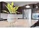 Close-up of a kitchen island featuring granite countertops, a plant, and stainless steel appliances in the background at 10934 Touchstone Loop, Parker, CO 80134