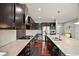 Modern kitchen with granite countertops, stainless steel appliances, and dark wood cabinetry with ample counter space at 10934 Touchstone Loop, Parker, CO 80134