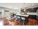 Open-concept kitchen featuring dark wood cabinets, granite counters, island with seating, and adjacent dining area at 10934 Touchstone Loop, Parker, CO 80134