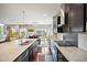 Bright kitchen featuring granite counters, stainless appliances, dark wood cabinets, and an open view to the dining room at 10934 Touchstone Loop, Parker, CO 80134
